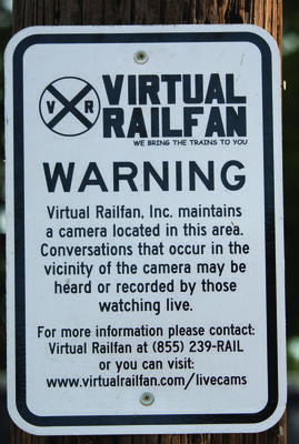 Warning sign mounted on the camera pole notifying visitors that audio is also being recorded.