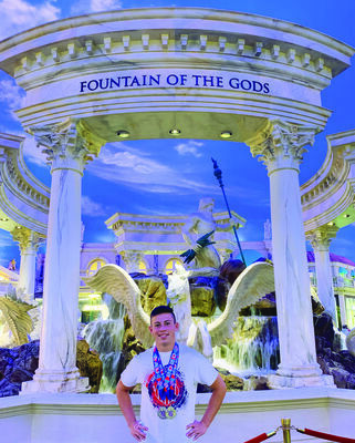 Michael pictured with his Olympic medals at Caesar's Palace in Las Vegas NV.  Photo by Mike Jitjaeng.
